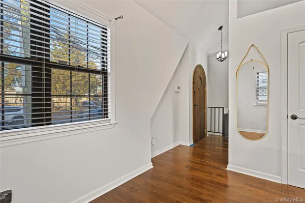 a view of an entryway with wooden floor