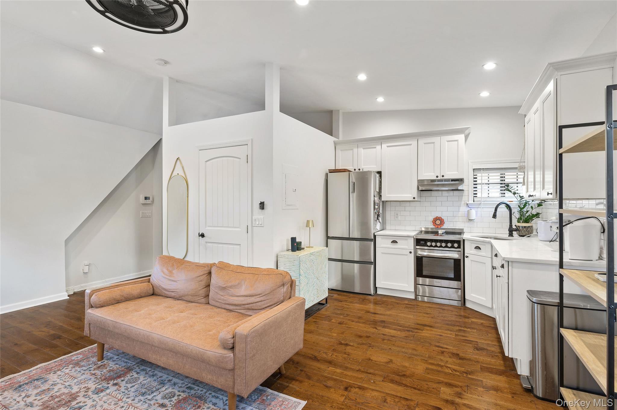 150 Kings Highway New Rochelle, NY 10801 - Photo 6 of 19 a large white kitchen with stainless steel appliances granite countertop a couch and a stove top oven