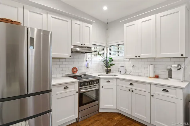 a kitchen with cabinets stainless steel appliances and a counter space