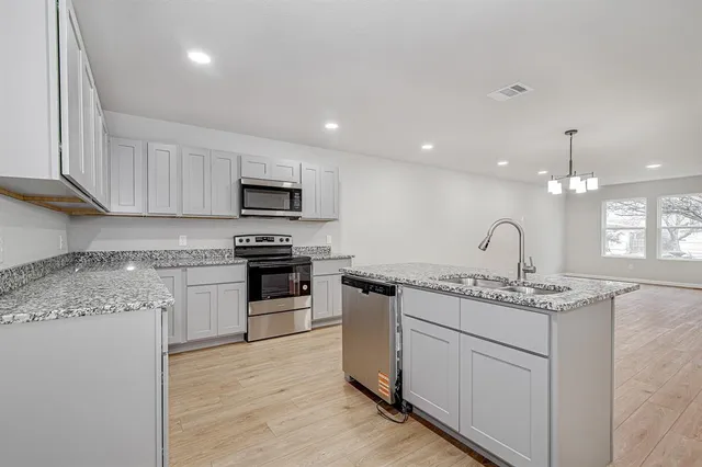 a kitchen with a sink stove and microwave