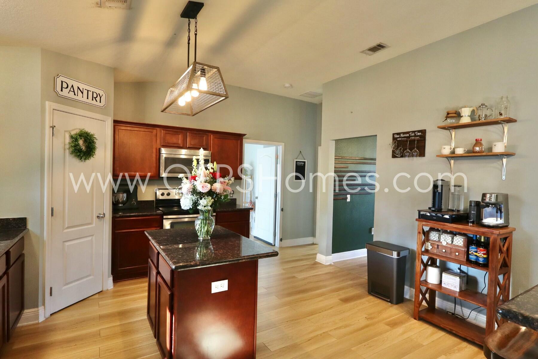 2400 Avenida De Sol Navarre, FL 32566 - Photo 11 of 42 a view of a dining room with furniture a kitchen and chandelier