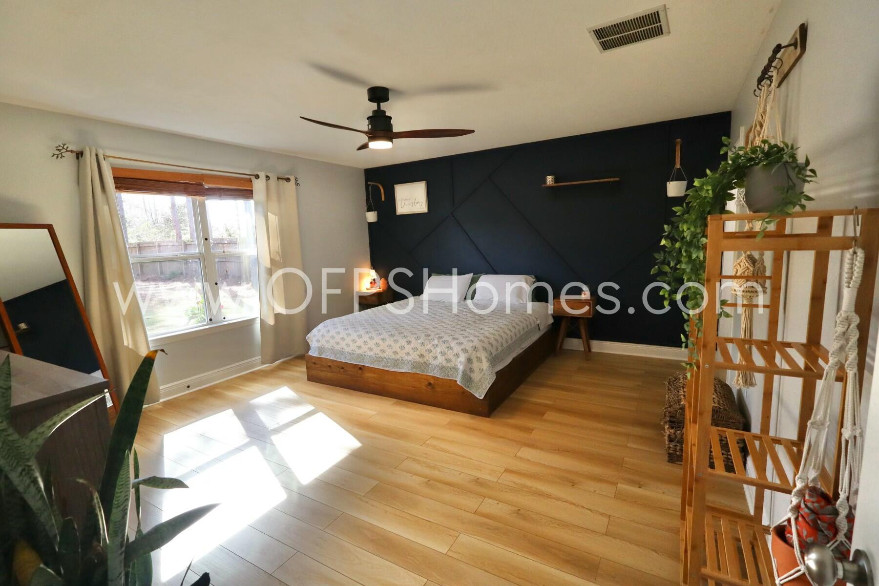 2400 Avenida De Sol Navarre, FL 32566 - Photo 12 of 42 a bedroom with a bed window and a flat tv screen