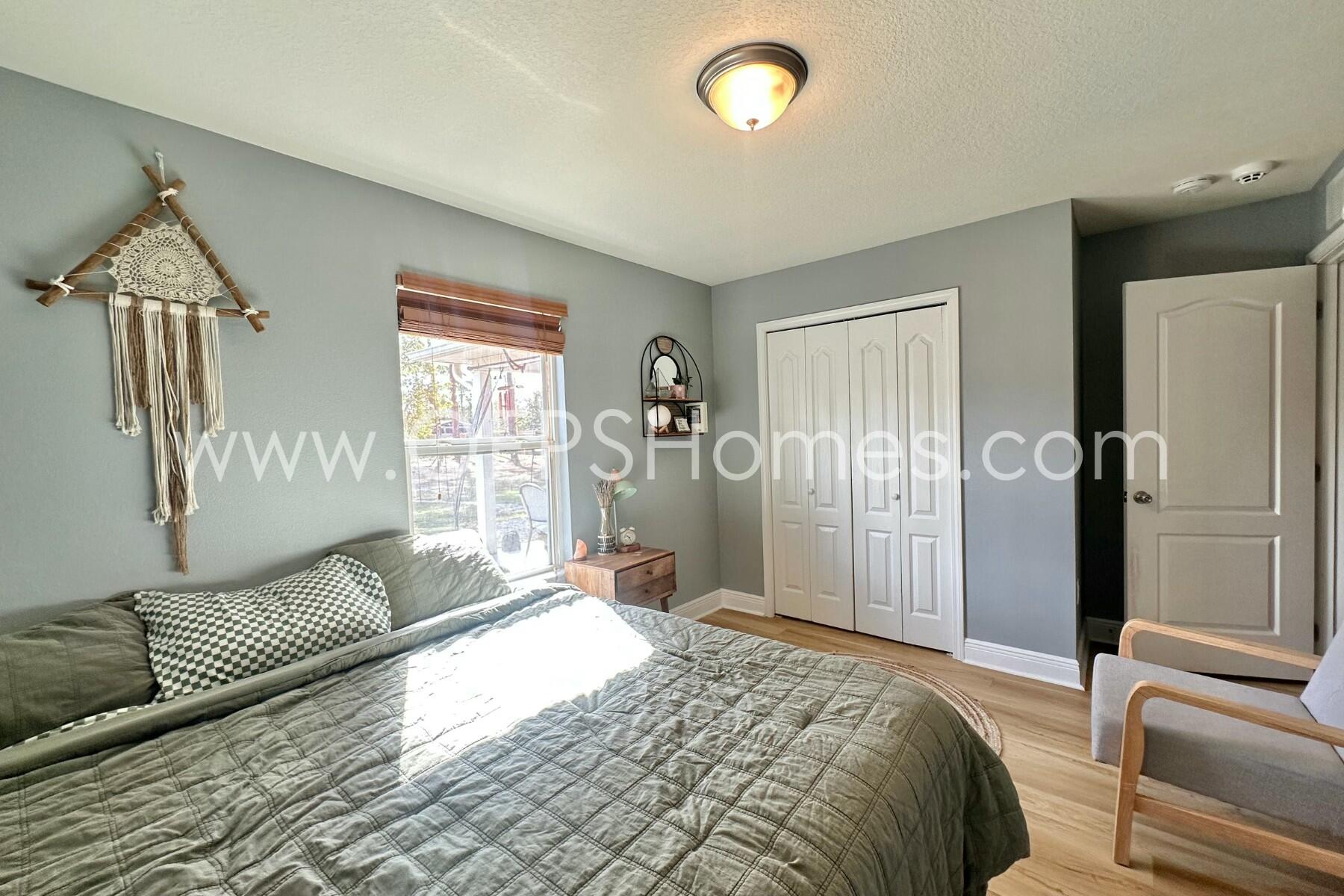 2400 Avenida De Sol Navarre, FL 32566 - Photo 22 of 42 a bedroom with a bed couch and a window