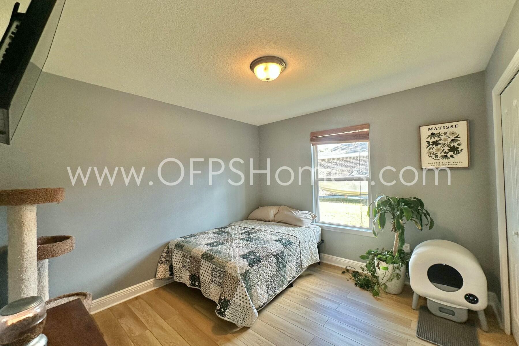 2400 Avenida De Sol Navarre, FL 32566 - Photo 24 of 42 a bedroom with a bed and painting on the wall