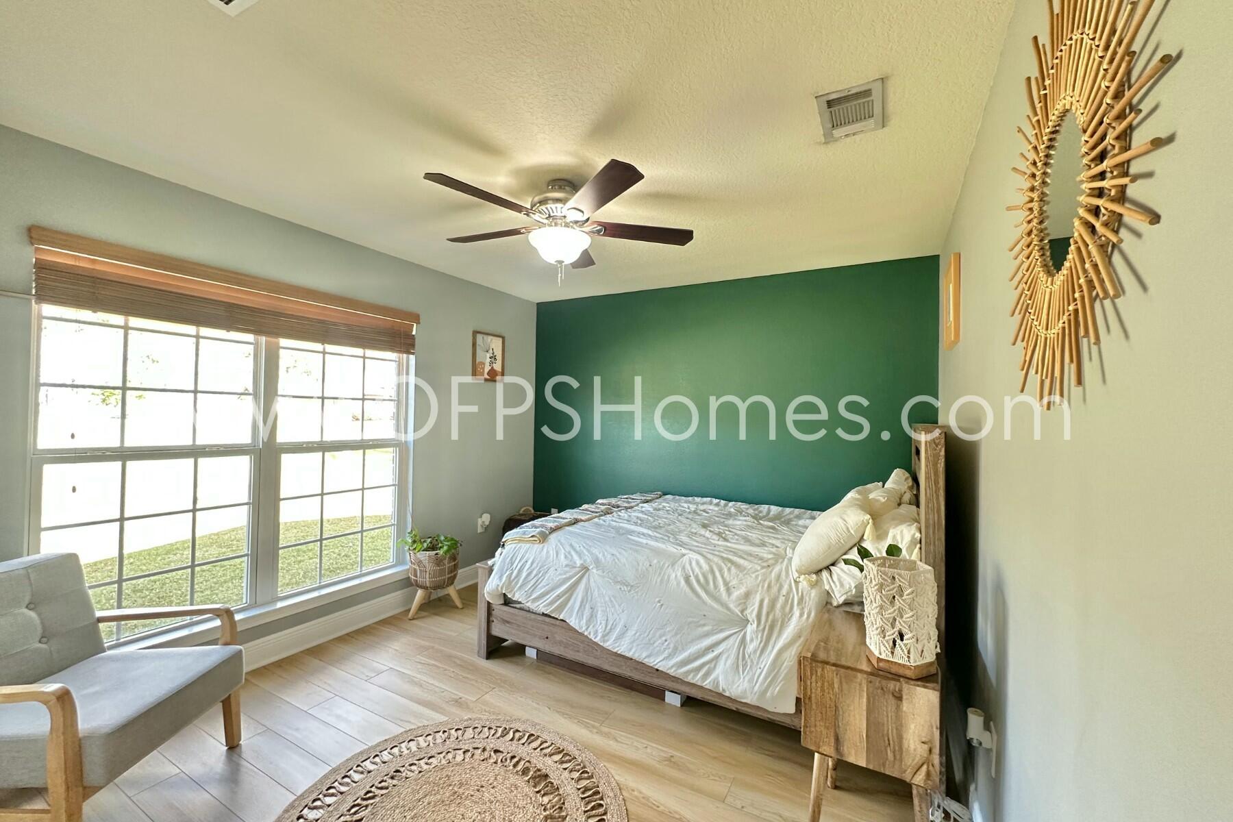 2400 Avenida De Sol Navarre, FL 32566 - Photo 27 of 42 a bedroom with a bed and a window