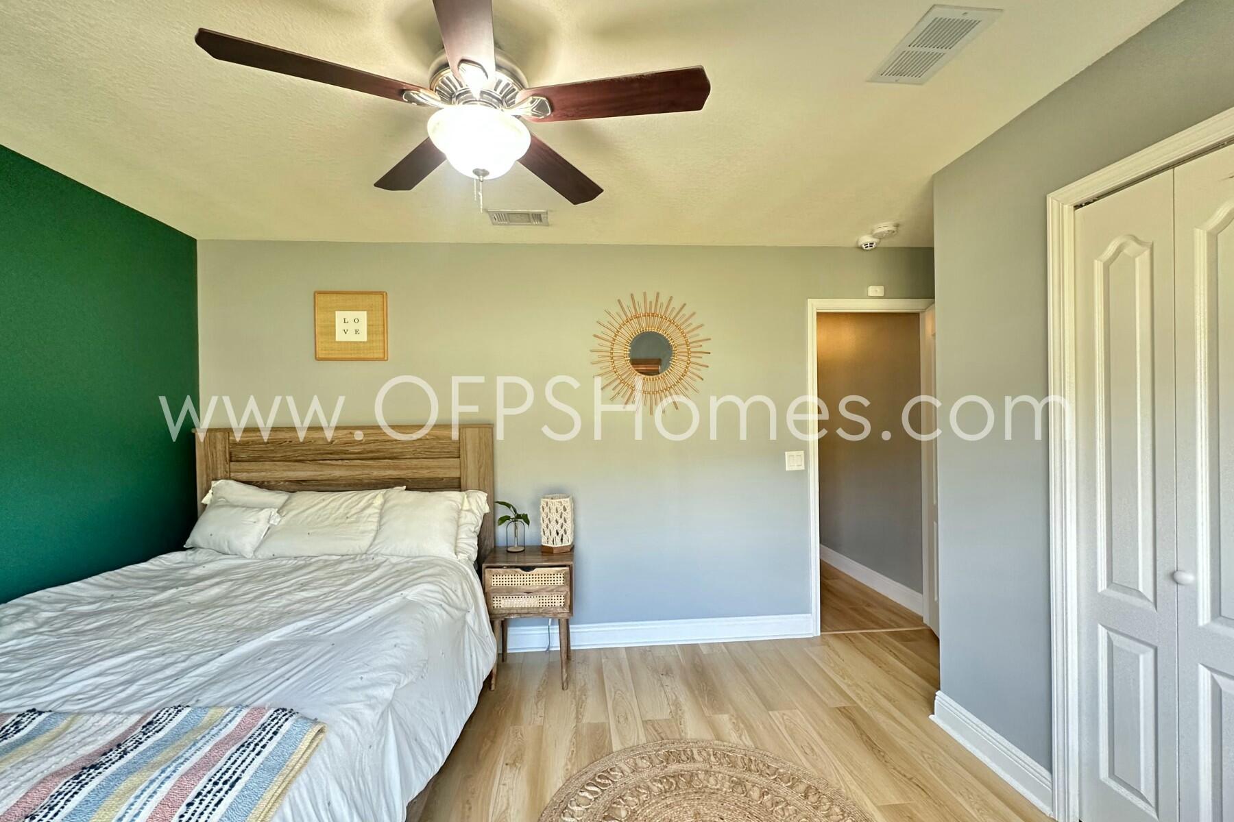 2400 Avenida De Sol Navarre, FL 32566 - Photo 29 of 42 a bedroom with a bed and a table