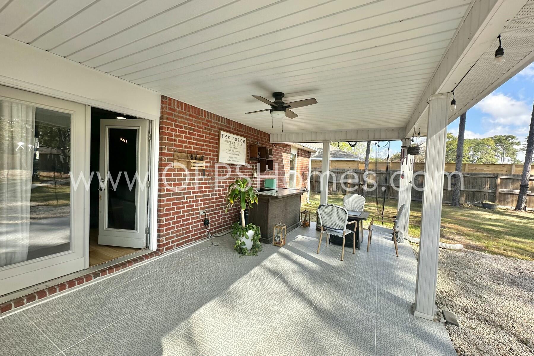 2400 Avenida De Sol Navarre, FL 32566 - Photo 30 of 42 a view of a patio with table and chairs and potted plants