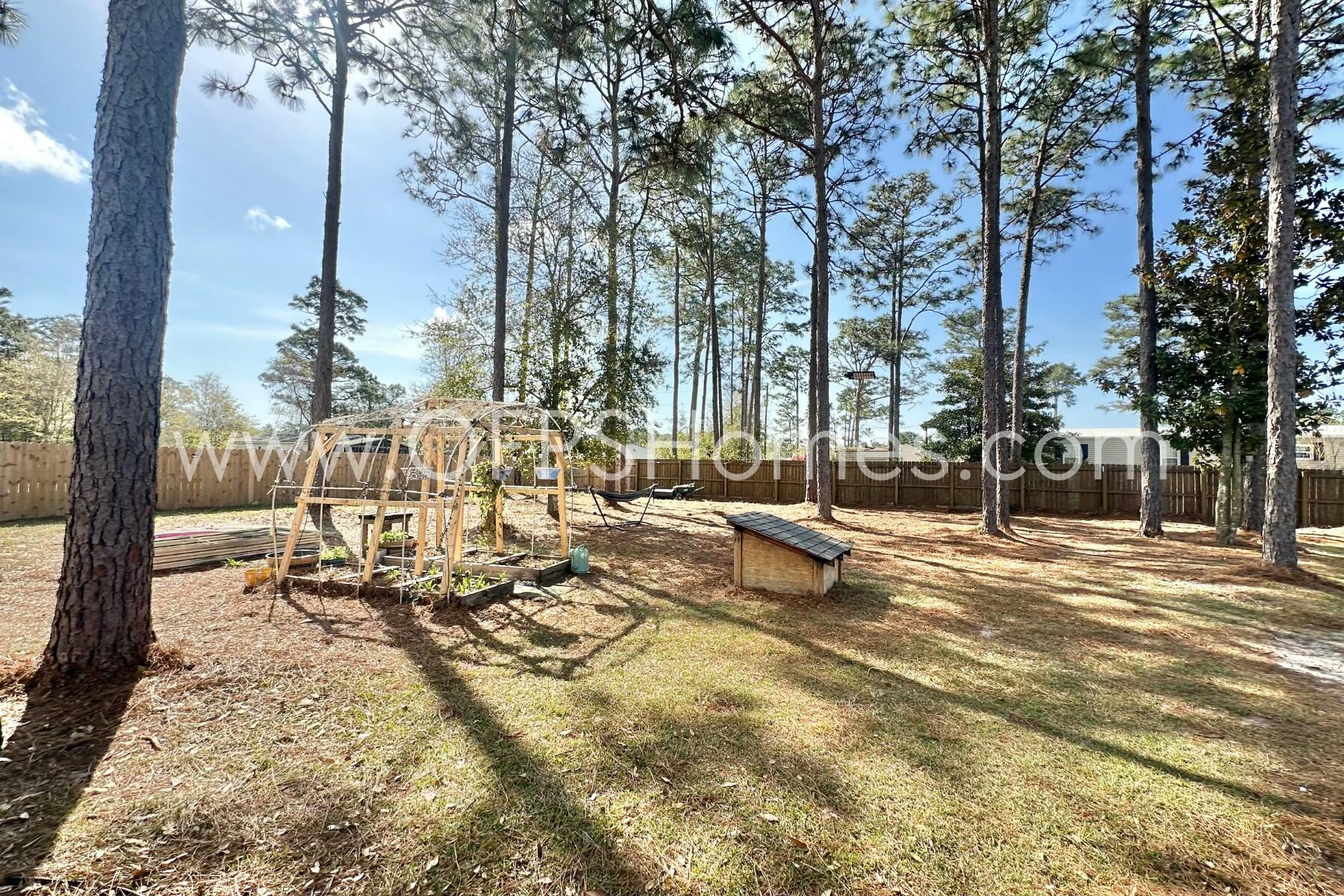 2400 Avenida De Sol Navarre, FL 32566 - Photo 35 of 42 a view of a park with swings and slides