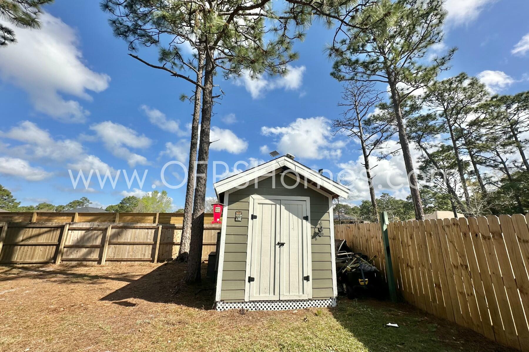 2400 Avenida De Sol Navarre, FL 32566 - Photo 38 of 42 a front view of a house with a yard
