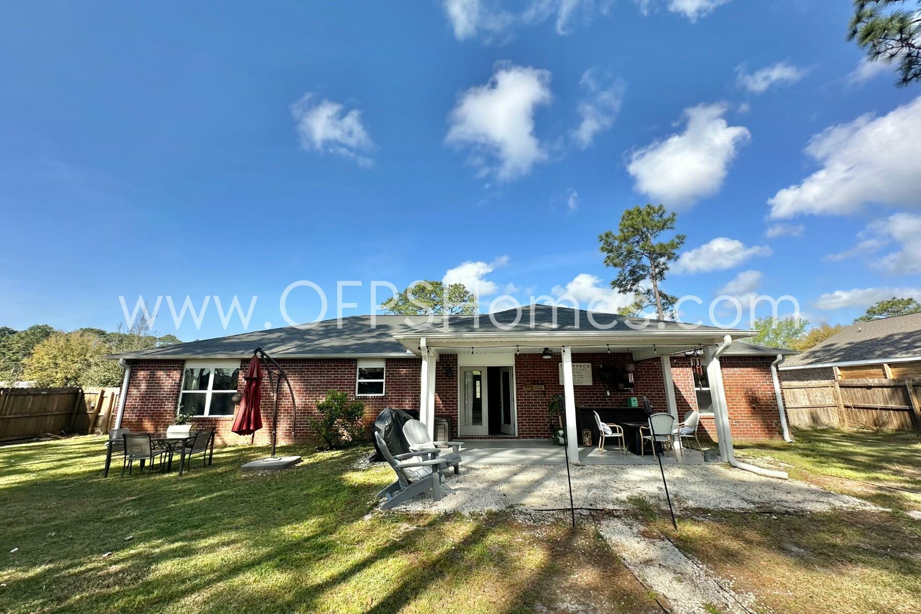 2400 Avenida De Sol Navarre, FL 32566 - Photo 39 of 42 a view of a building with a swimming pool and sitting area