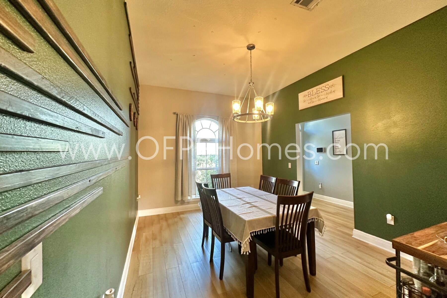 2400 Avenida De Sol Navarre, FL 32566 - Photo 5 of 42 a view of a dining room with furniture and wooden floor
