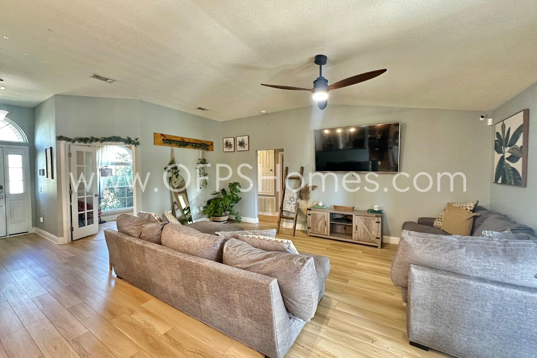 2400 Avenida De Sol Navarre, FL 32566 - Photo 8 of 42 a living room with furniture a flat screen tv and a fireplace