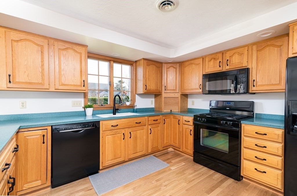 42 Ralston Road Weymouth, MA 02190 - Photo 8 of 34 a kitchen with stainless steel appliances granite countertop a stove a sink and a microwave