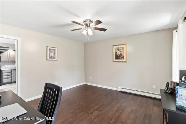 a view of room with hardwood floor and ceiling fan