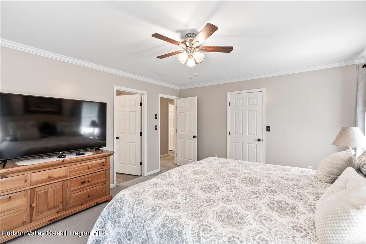 29 Stone Mountain Road Round Top, NY 12473 - Photo 18 of 36 a bedroom with a bed and a flat screen tv