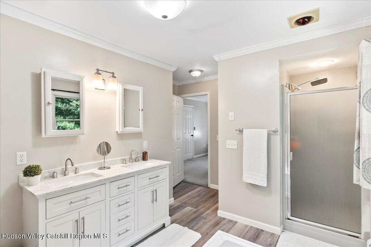 29 Stone Mountain Road Round Top, NY 12473 - Photo 19 of 36 a bathroom with a double vanity sink mirror and shower