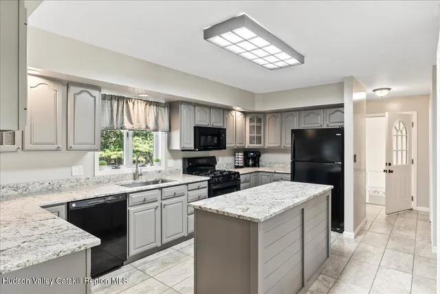 a kitchen with a sink stove and refrigerator