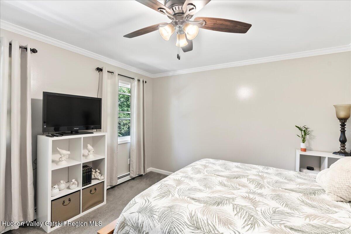 29 Stone Mountain Road Round Top, NY 12473 - Photo 23 of 36 a bedroom with a bed and a flat screen tv