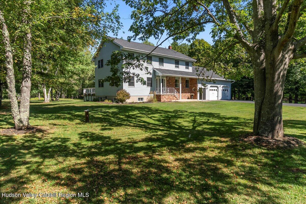 29 Stone Mountain Road Round Top, NY 12473 - Photo 30 of 36 a front view of a house with a garden