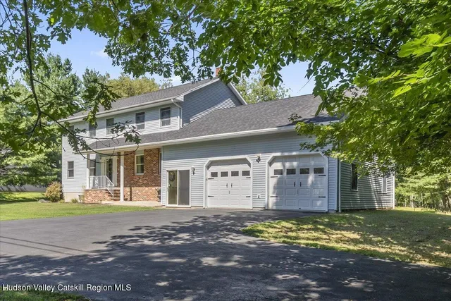 a front view of house with outdoor space and swimming pool