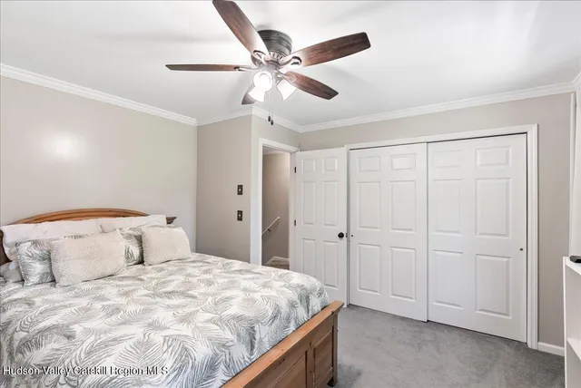 a bedroom with a bed and a ceiling fan