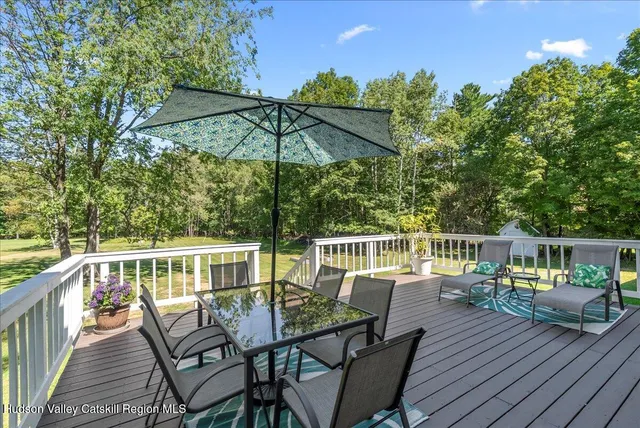 a view of a deck with furniture and umbrella