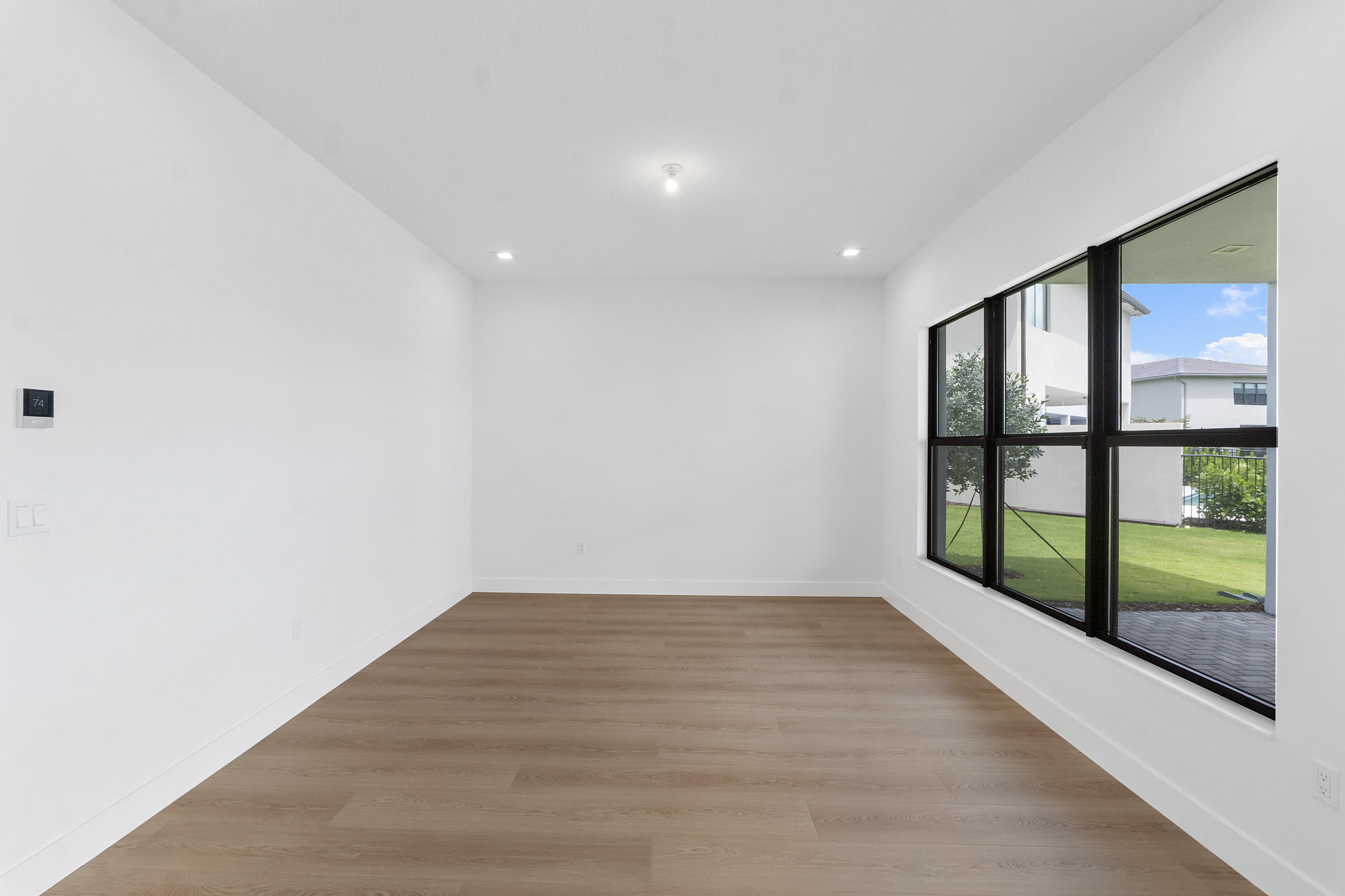 9322 Sunflower Mdw Road Boca Raton, FL 33434 - Photo 24 of 87 a view of empty room with wooden floor and fan