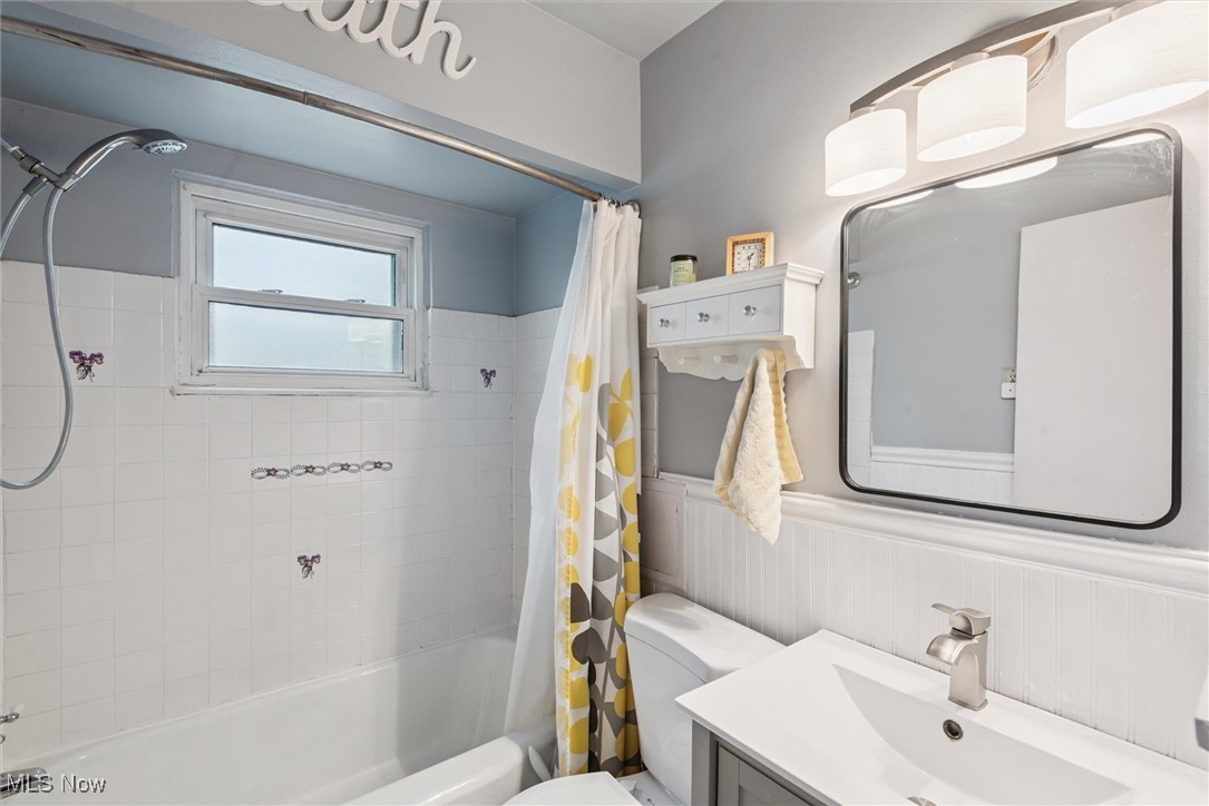 6234 Holburn Road Parma, OH 44129 - Photo 16 of 34 Bathroom with shower / bath combo, wainscoting, and vanity
