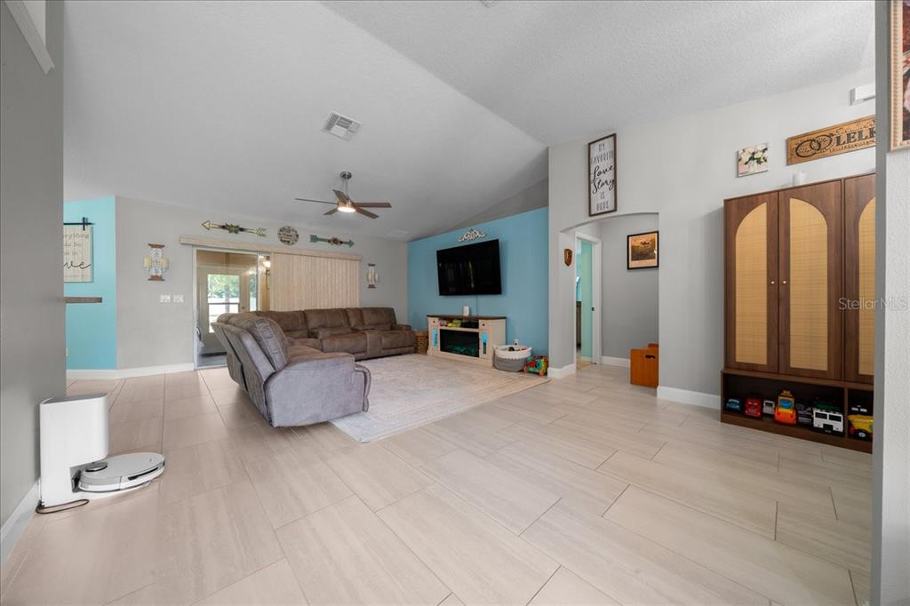 5321 Southwest 115th Loop Ocala, FL 34476 - Photo 12 of 49 a living room with furniture and a flat screen tv