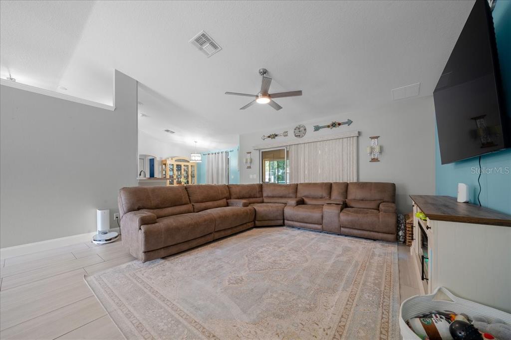 5321 Southwest 115th Loop Ocala, FL 34476 - Photo 13 of 49 a living room with furniture and a flat screen tv