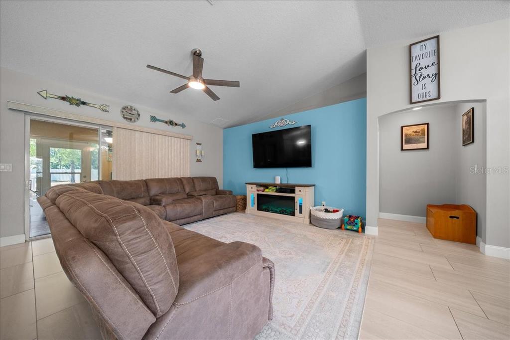 5321 Southwest 115th Loop Ocala, FL 34476 - Photo 14 of 49 a living room with furniture and a flat screen tv