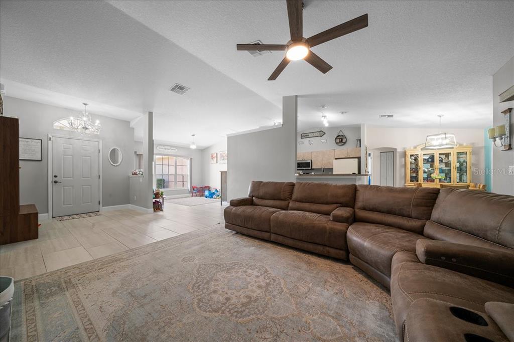5321 Southwest 115th Loop Ocala, FL 34476 - Photo 16 of 49 a living room with furniture and a chandelier