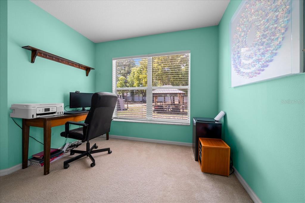 5321 Southwest 115th Loop Ocala, FL 34476 - Photo 27 of 49 a view of a workspace with furniture and a window