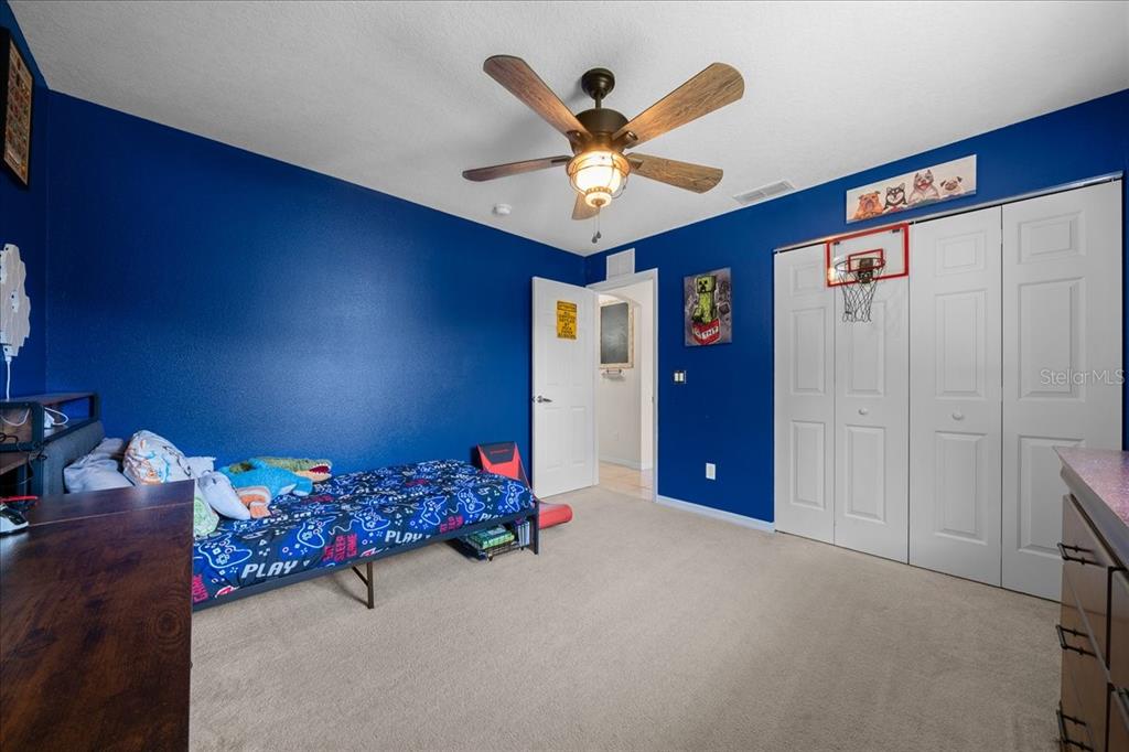 5321 Southwest 115th Loop Ocala, FL 34476 - Photo 34 of 49 a bedroom with a bed and a chandelier