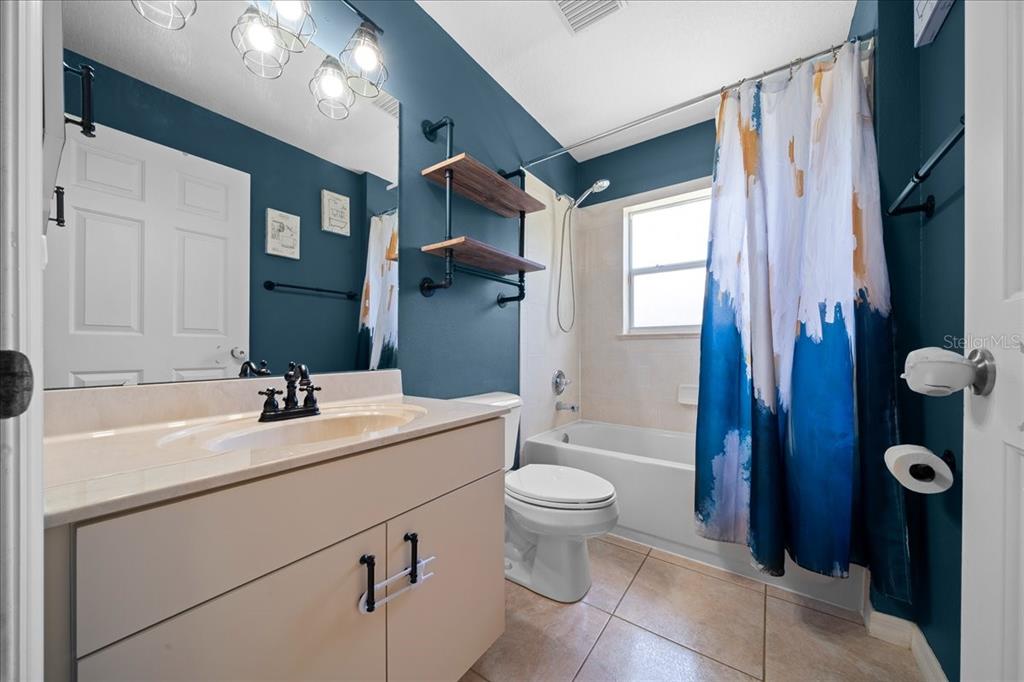 5321 Southwest 115th Loop Ocala, FL 34476 - Photo 35 of 49 a bathroom with a sink a toilet and shower