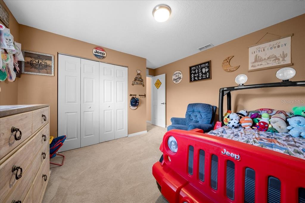 5321 Southwest 115th Loop Ocala, FL 34476 - Photo 37 of 49 a bedroom with furniture and a baby crib