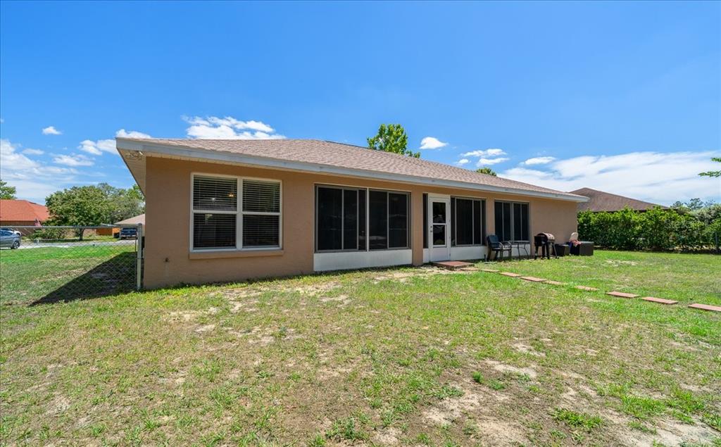 5321 Southwest 115th Loop Ocala, FL 34476 - Photo 45 of 49 a front view of a house with a yard