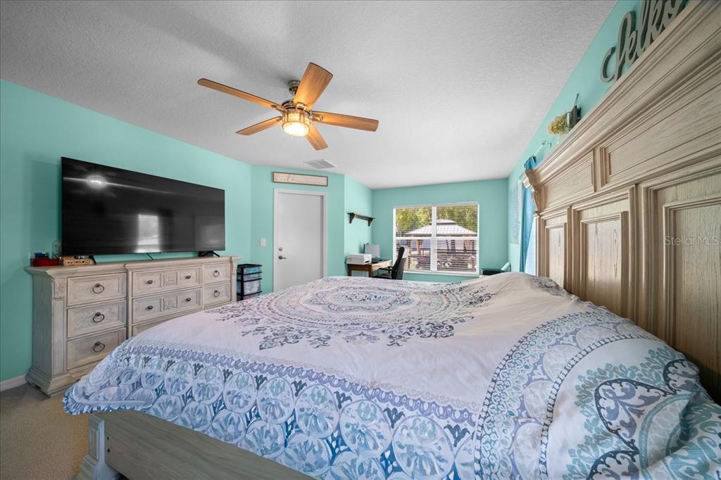 5321 Southwest 115th Loop Ocala, FL 34476 - Photo 49 of 49 a bedroom with a bed and a flat screen tv