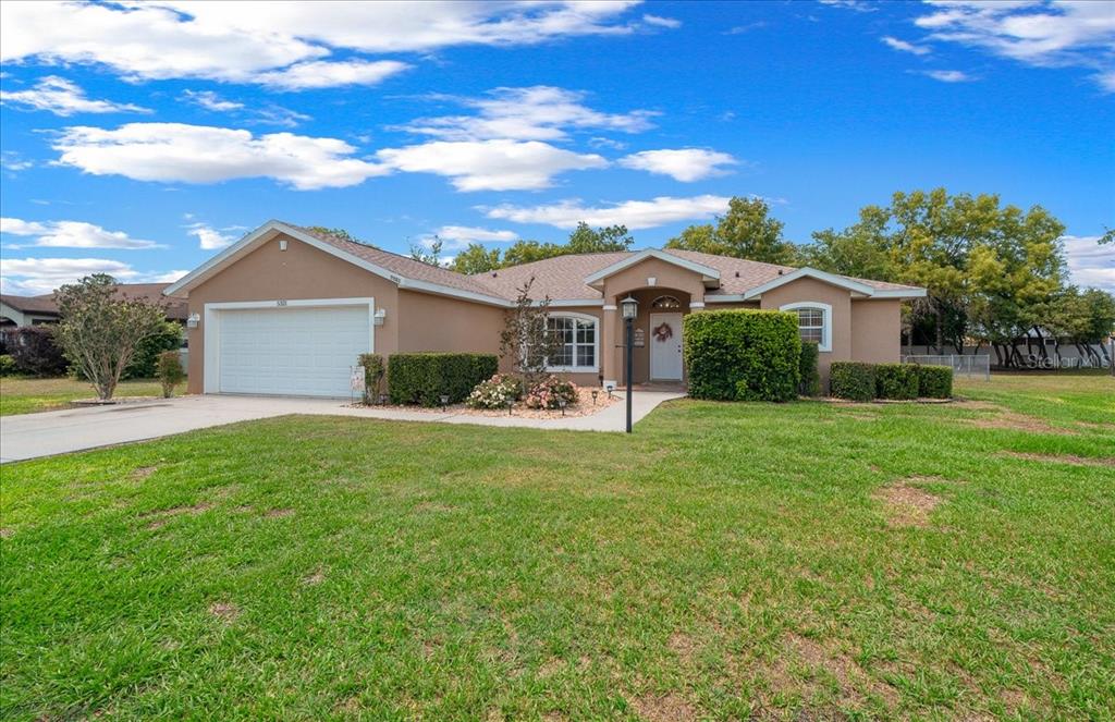5321 Southwest 115th Loop Ocala, FL 34476 - Photo 6 of 49 a front view of a house with a garden