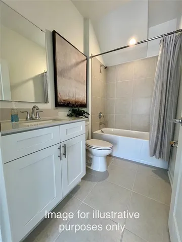 a bathroom with a shower sink vanity and toilet