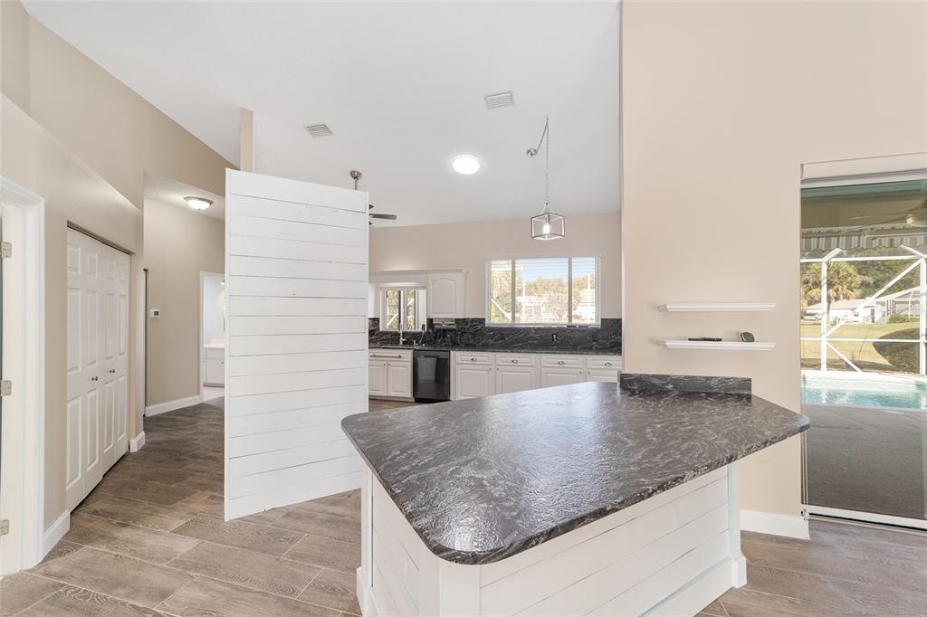 5565 Northwest 26th Lane Ocala, FL 34482 - Photo 14 of 59 an open kitchen with kitchen island a sink appliances and a counter space