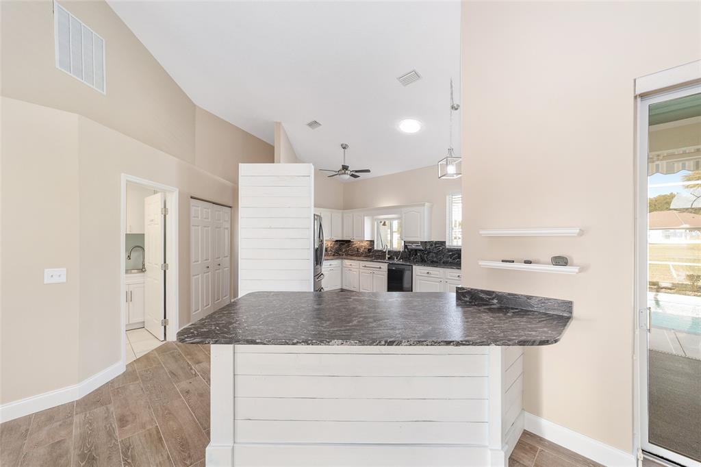 5565 Northwest 26th Lane Ocala, FL 34482 - Photo 15 of 59 a kitchen with granite countertop a sink and cabinets