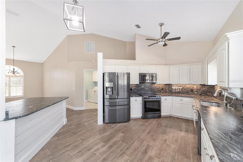 5565 Northwest 26th Lane Ocala, FL 34482 - Photo 18 of 59 a kitchen with a refrigerator and a sink