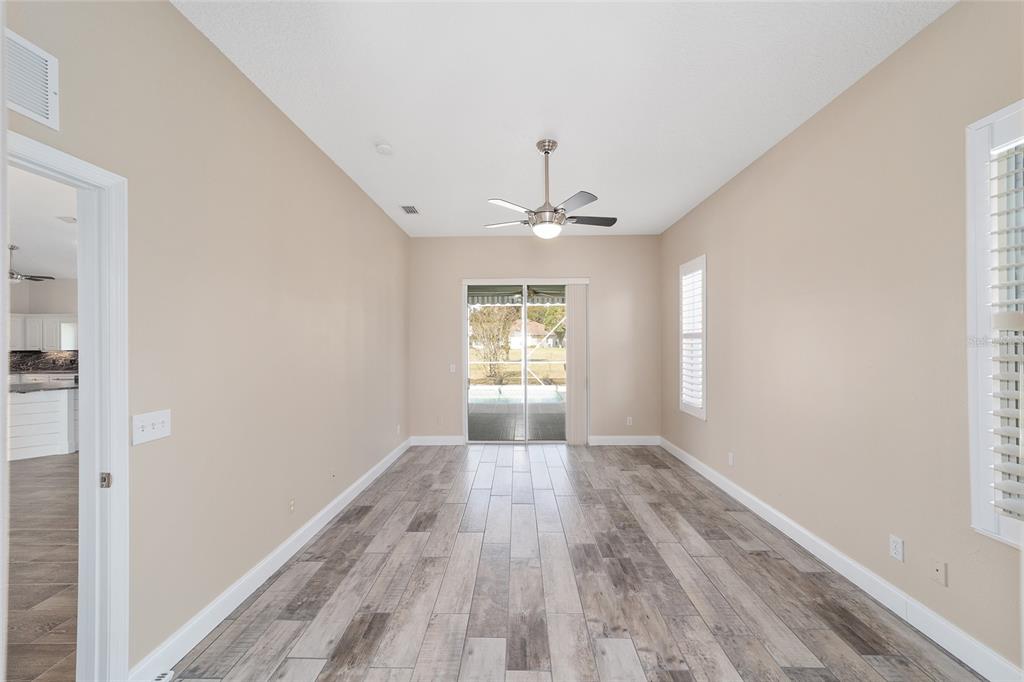5565 Northwest 26th Lane Ocala, FL 34482 - Photo 22 of 59 a view of wooden floor and chandelier in a room