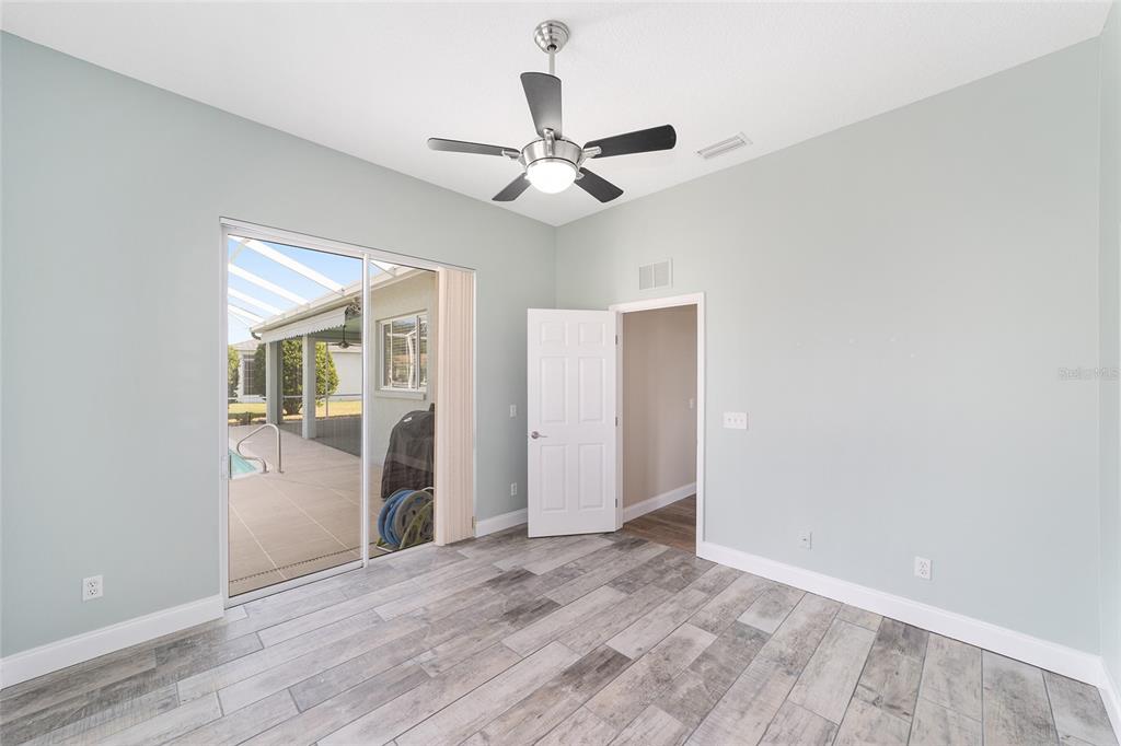5565 Northwest 26th Lane Ocala, FL 34482 - Photo 33 of 59 an empty room with wooden floor a ceiling fan and closet