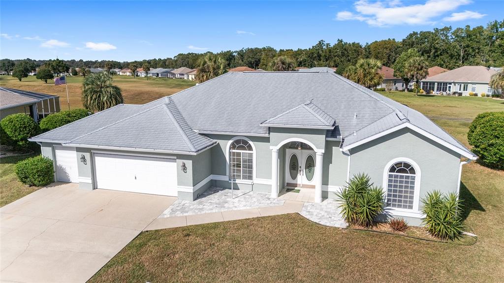5565 Northwest 26th Lane Ocala, FL 34482 - Photo 50 of 59 a front view of a house with a yard and garage