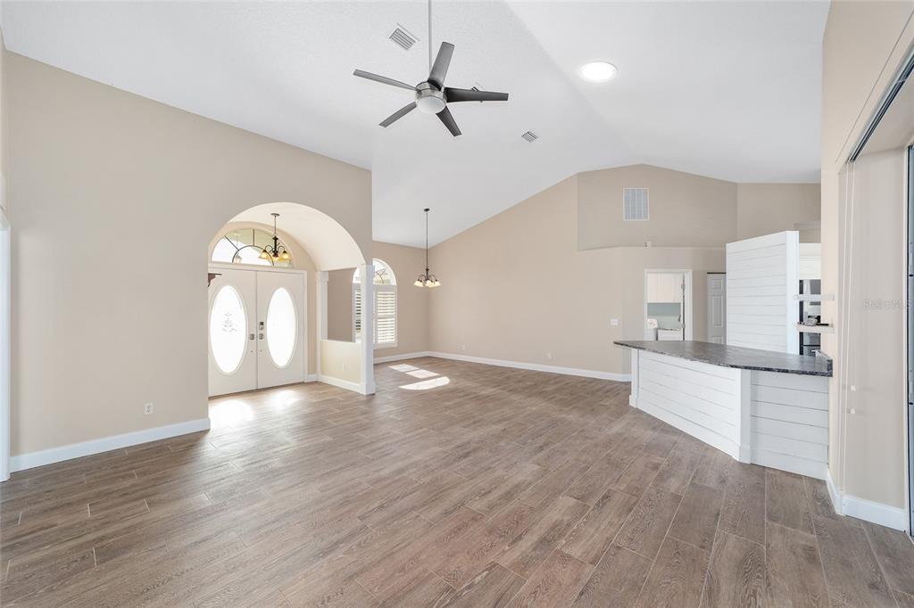 5565 Northwest 26th Lane Ocala, FL 34482 - Photo 8 of 59 an empty room with wooden floor fan and windows