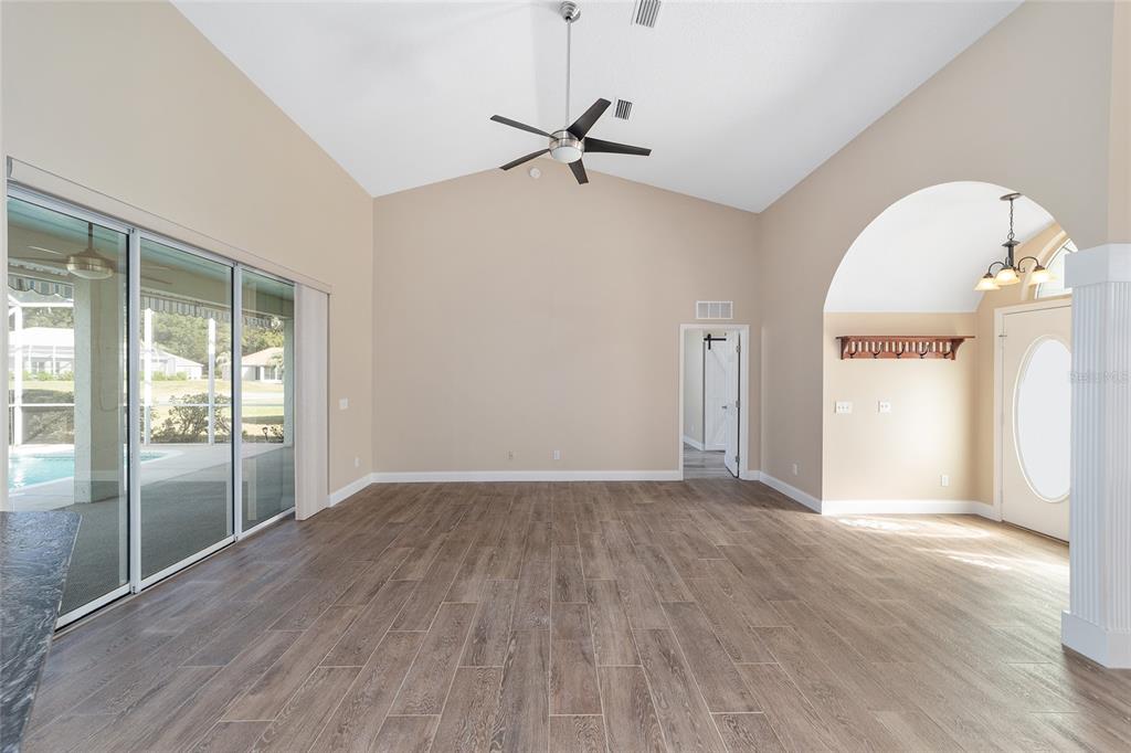 5565 Northwest 26th Lane Ocala, FL 34482 - Photo 10 of 59 a view of a livingroom with wooden floor and a ceiling fan