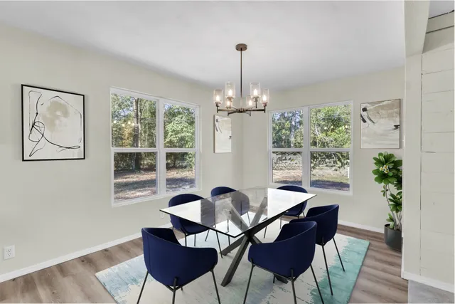 a view of a dining room with furniture window and wooden floor
