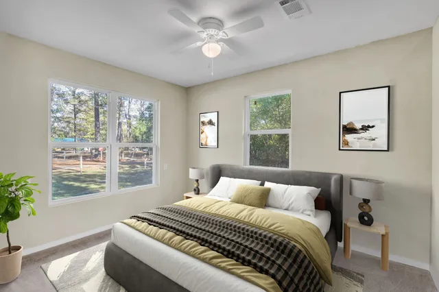 a bedroom with a large bed and a window